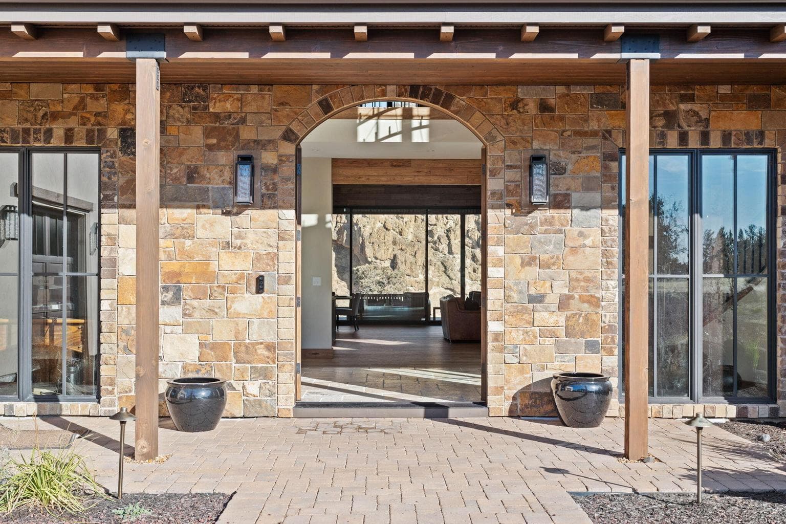 As you walk to the front doors you look thru the home to the Canyon walls.