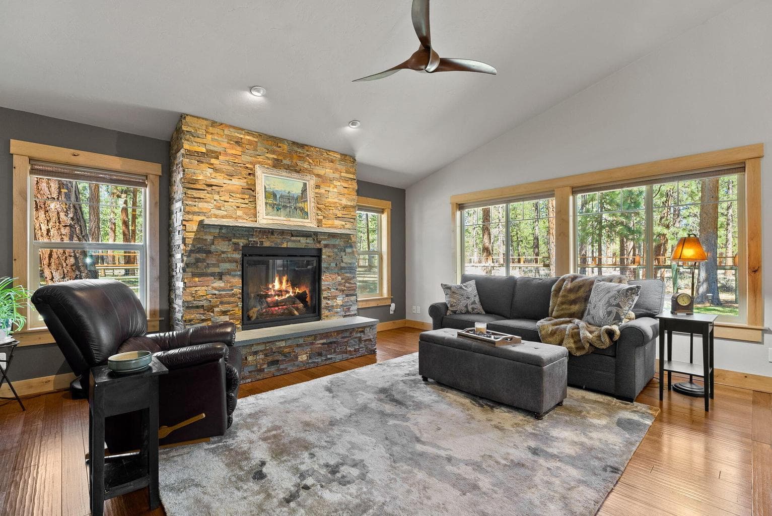 Light-filled great room with floor-to-ceiling Tibetan stone fireplace
