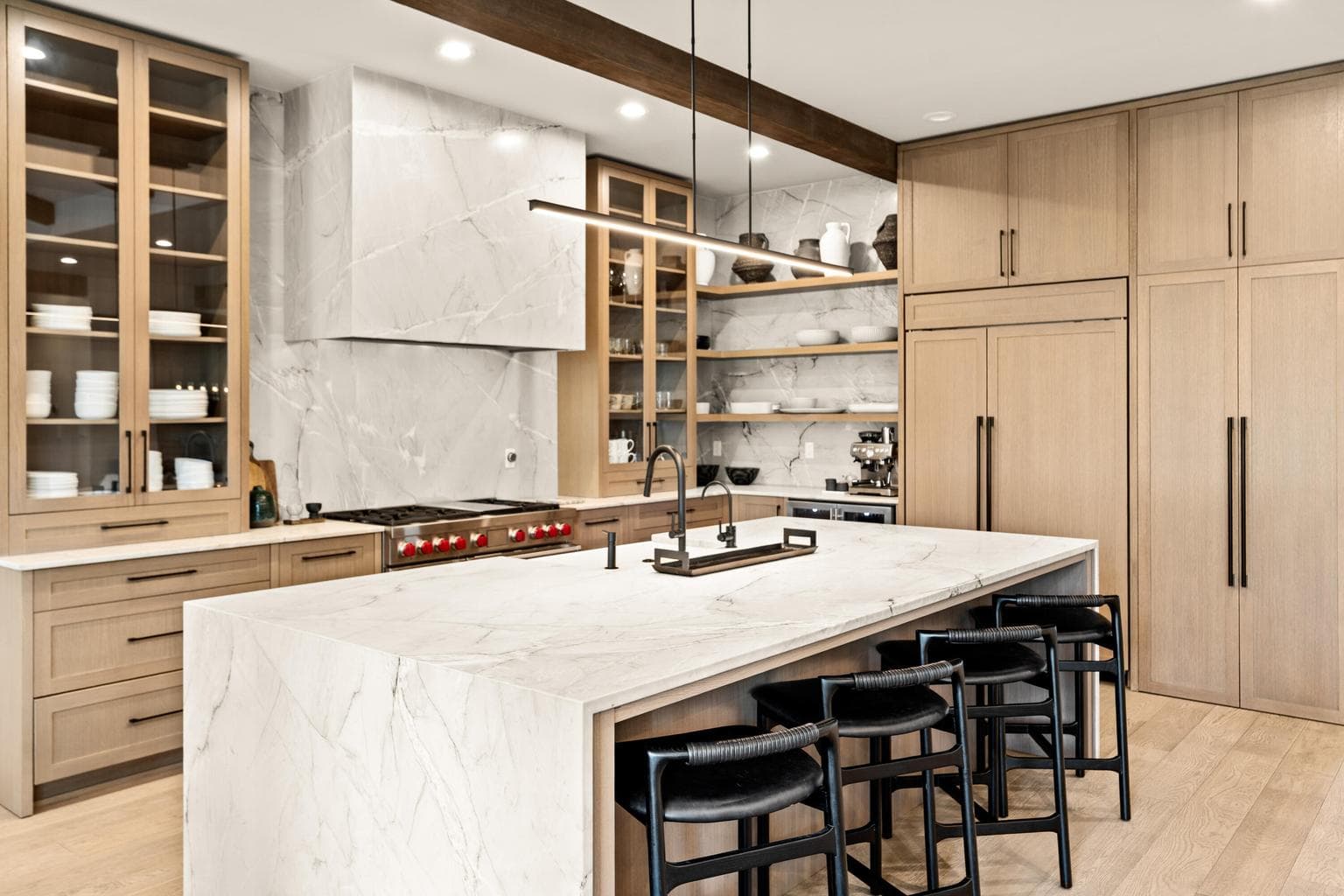 Features a chef’s kitchen with granite counters, dual dishwashers, and a large island.