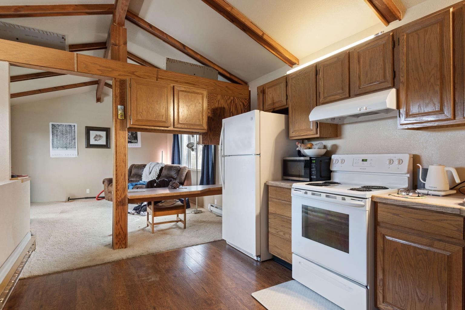 Units 1 and 2 have living rooms, kitchens, and half baths on the main level.