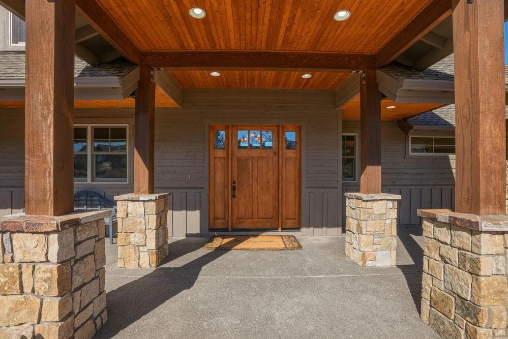 Covered front patio with Northwest stone and wood touches