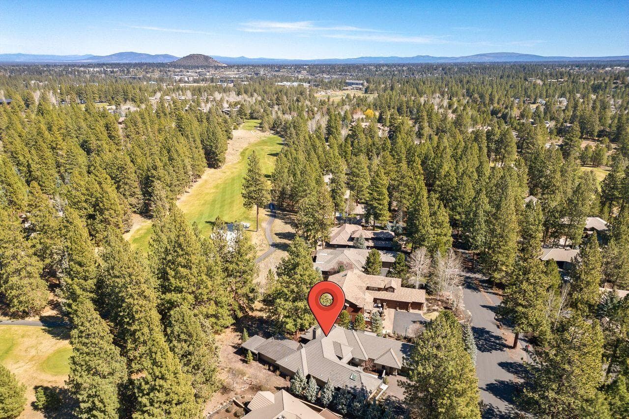 Aerial perspective highlighting the home’s position within Broken Top, backing to the 3rd green and surrounded by mature Ponderosa pines. The setting offers a rare combination of privacy and connection to the course, with the home thoughtfully set back from play while still enjoying the natural openness and views of the fairway. A unique opportunity to enjoy golf course living within a peaceful, established neighborhood setting.