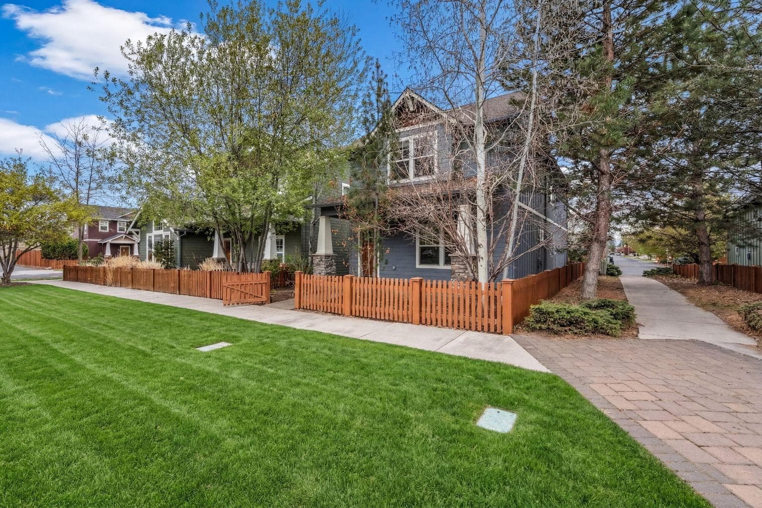 Fully fenced-in backyard/side yard with low-maintenance landscaping.