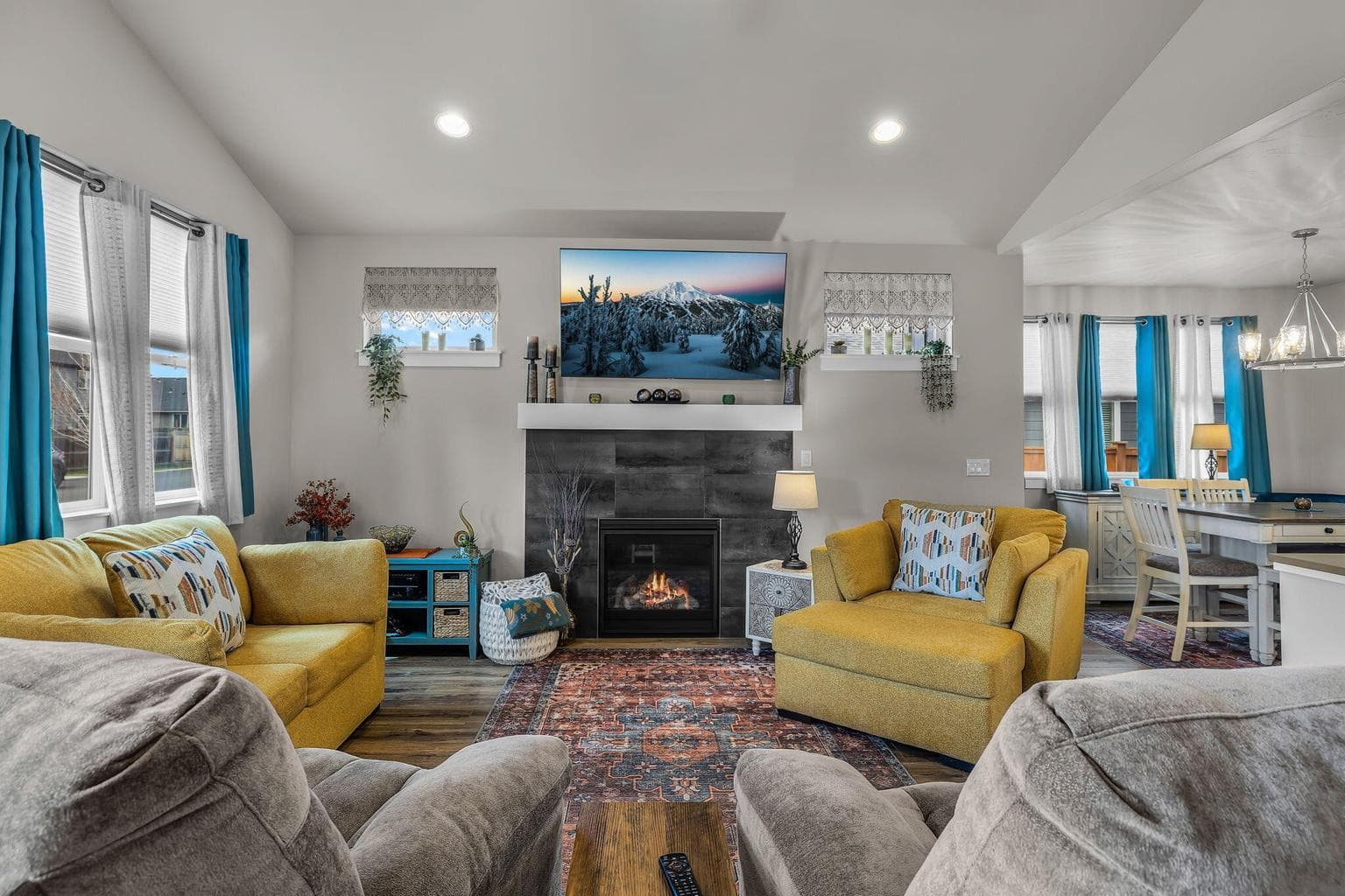 Spacious great room with vaulted ceilings and a cozy gas fireplace with mantle.