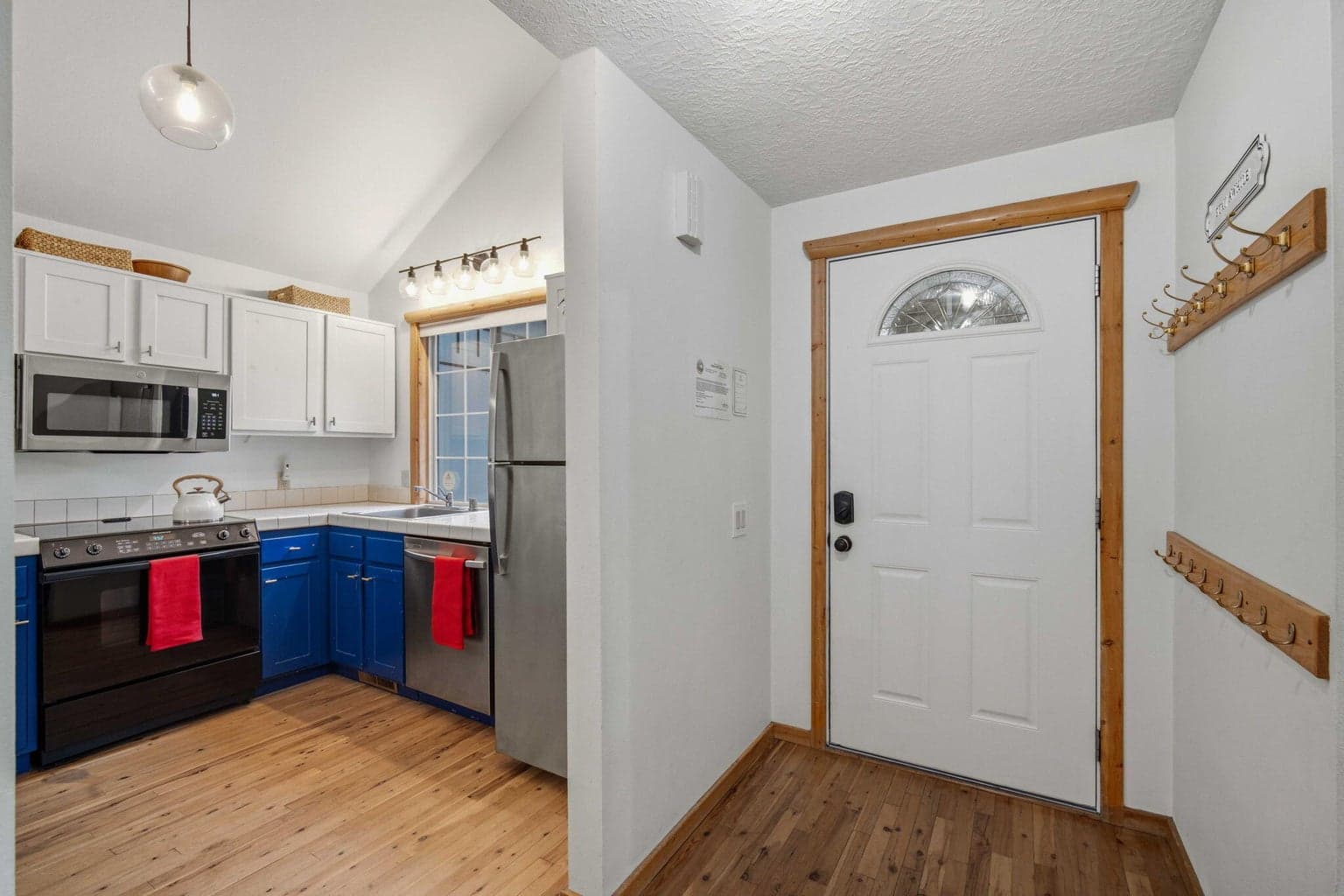 Front entrance, opens onto hard wood flooring and kitchen