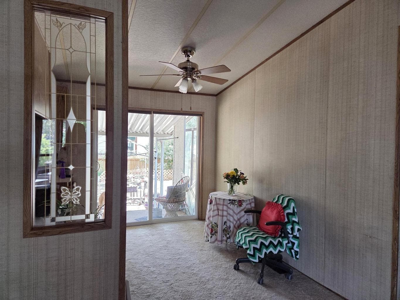Dining area has a sliding glass door that leads to the large backyard and covered deck.
