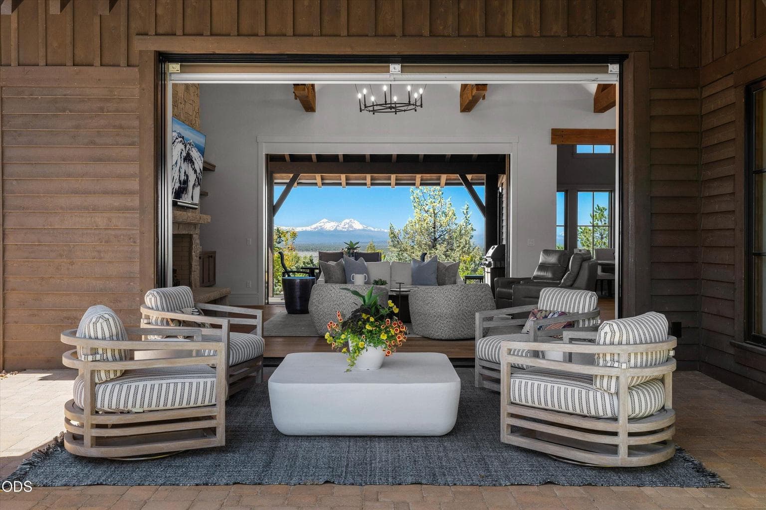 Covered front patio with multi-slide pocket doors on both sides of the Great Room, opening the home up to the east and west outdoor living areas