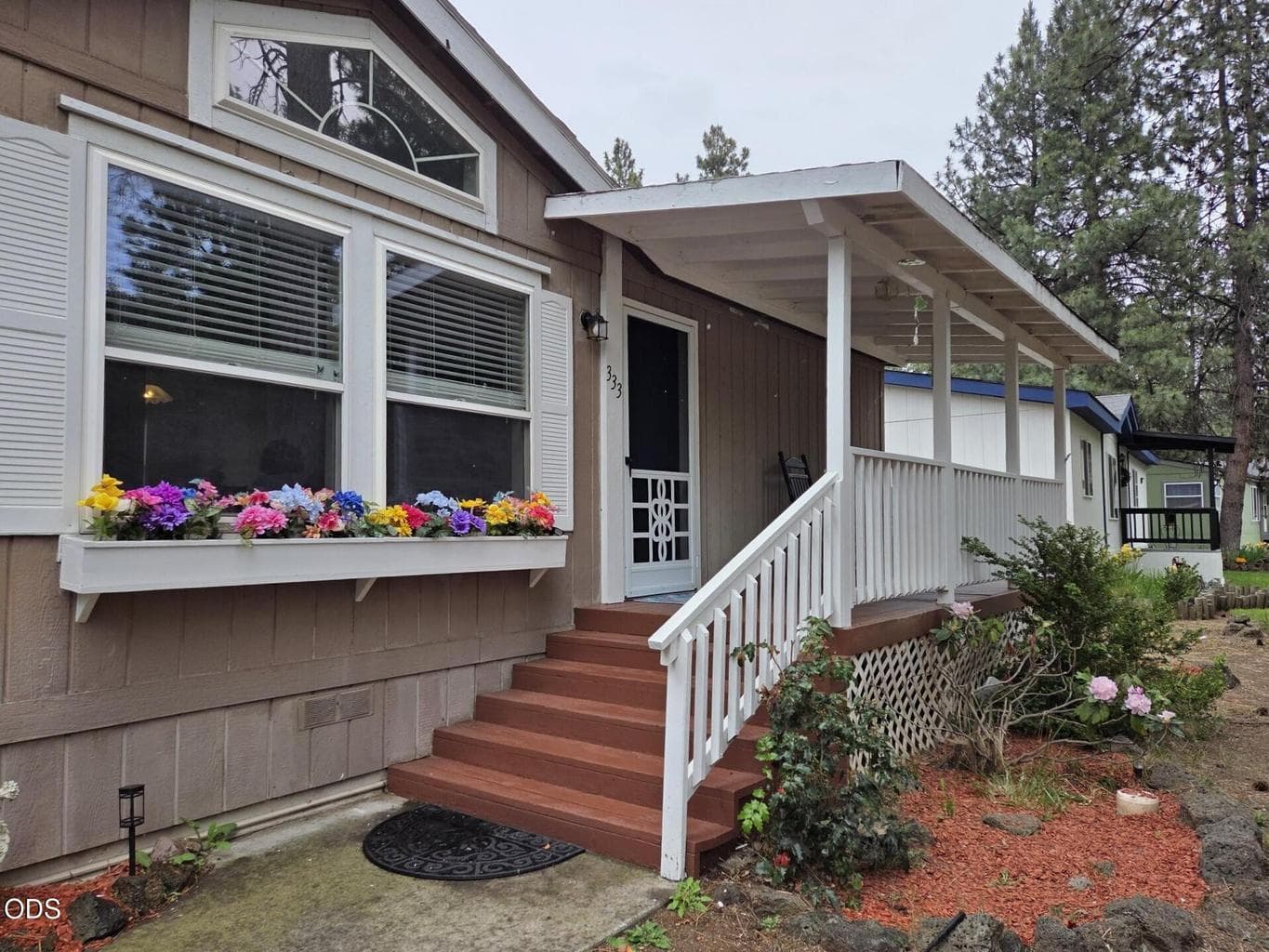 Welcome home, freshly painted covered front porch with new screen door.