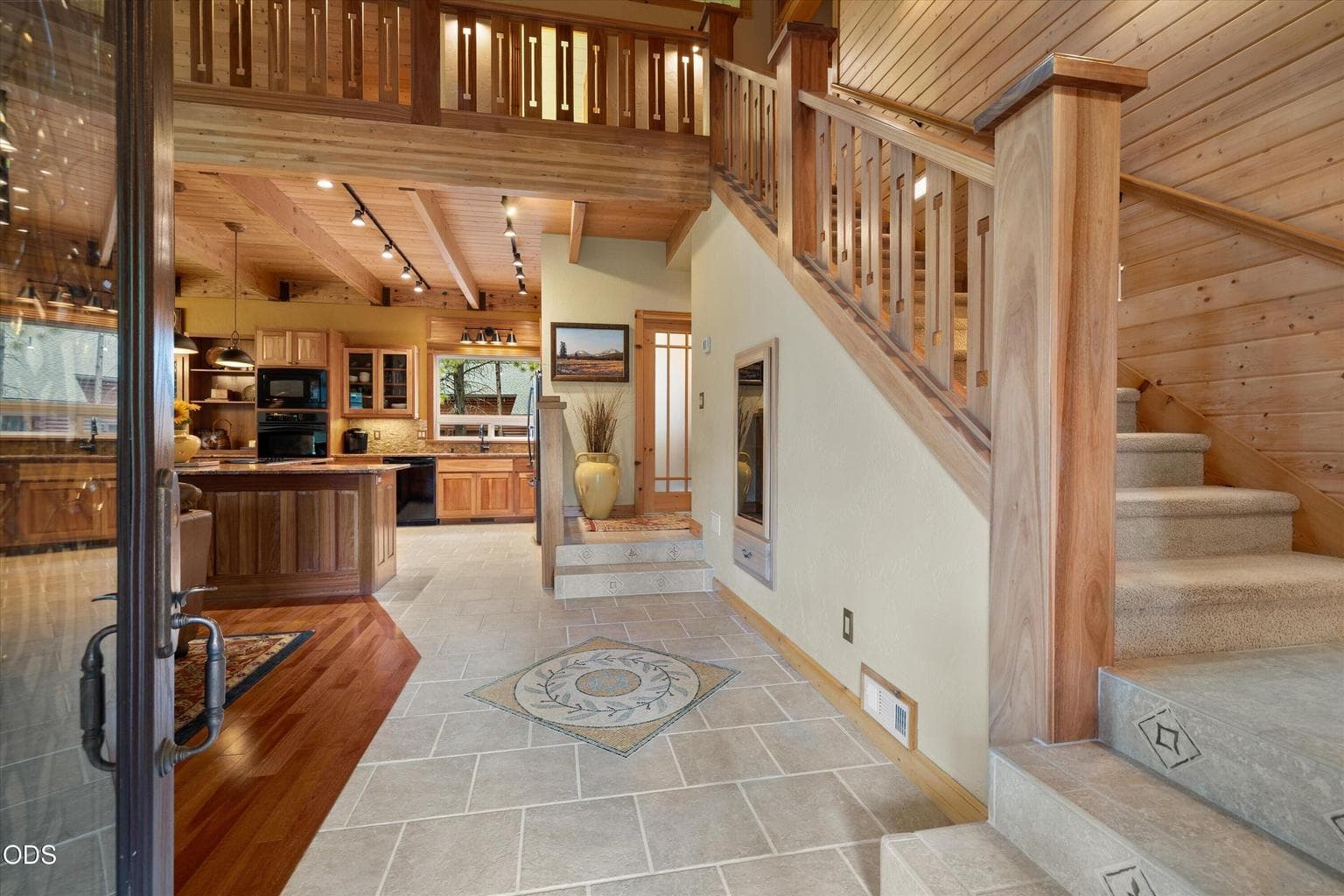 Welcoming entry features custom tile mosaic and millwork accents.