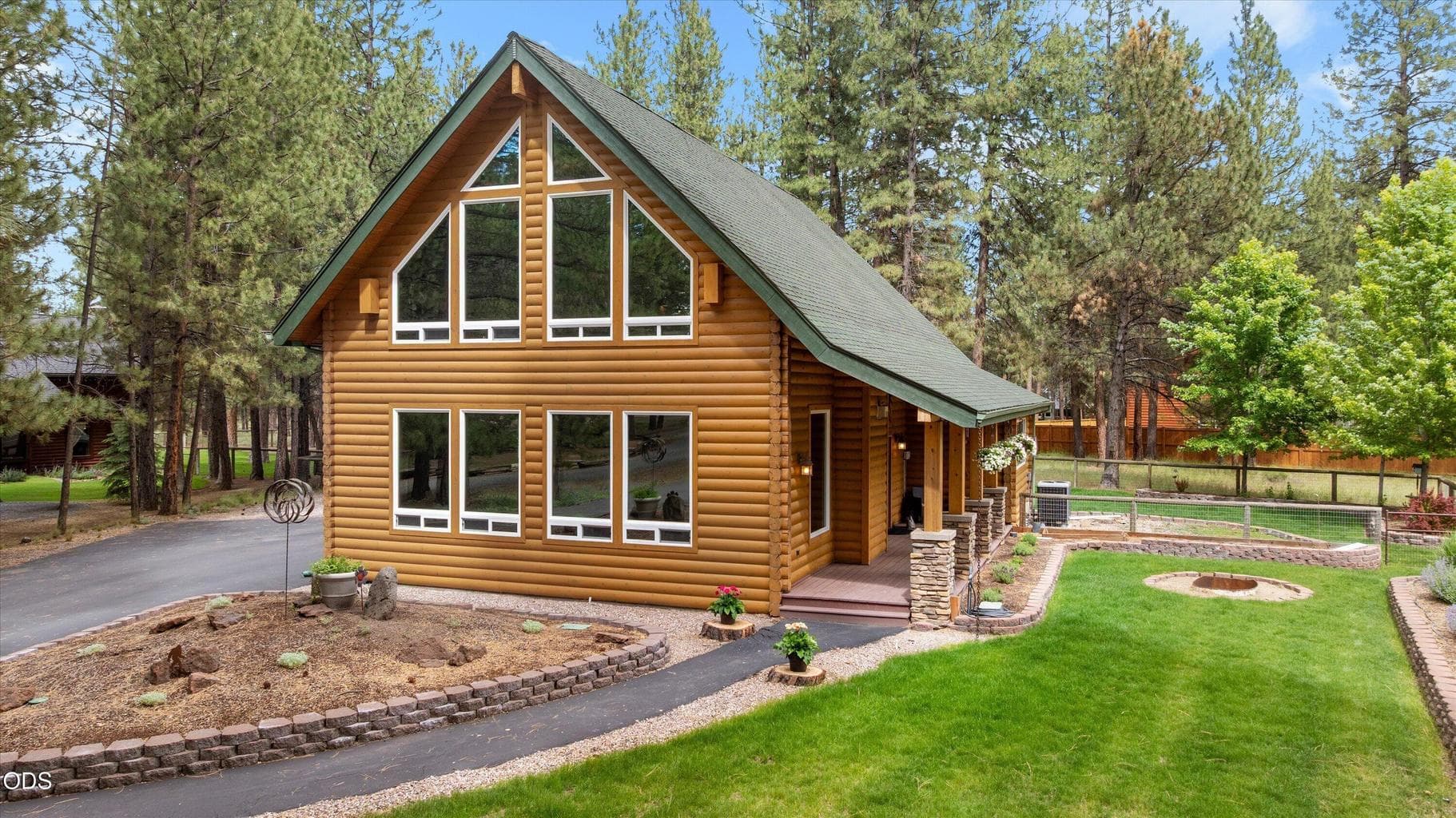 Stone columns and wood posts line the covered porch entry.