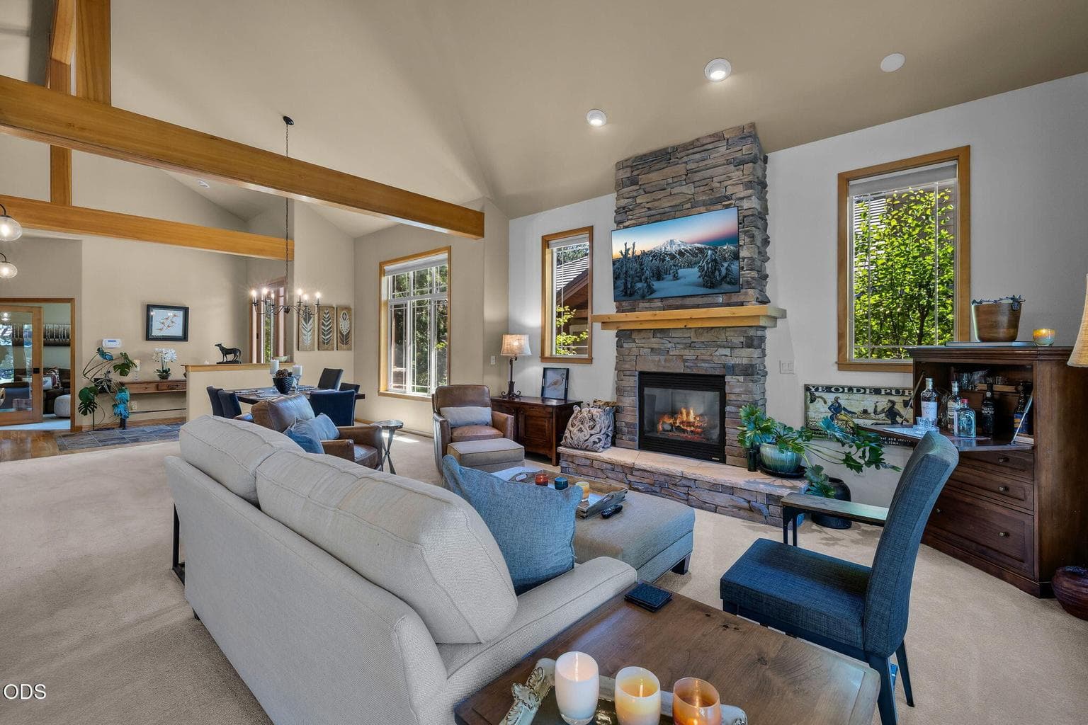 Spacious great room with vaulted ceilings, stone fireplace, large windows and golf course outlooks.