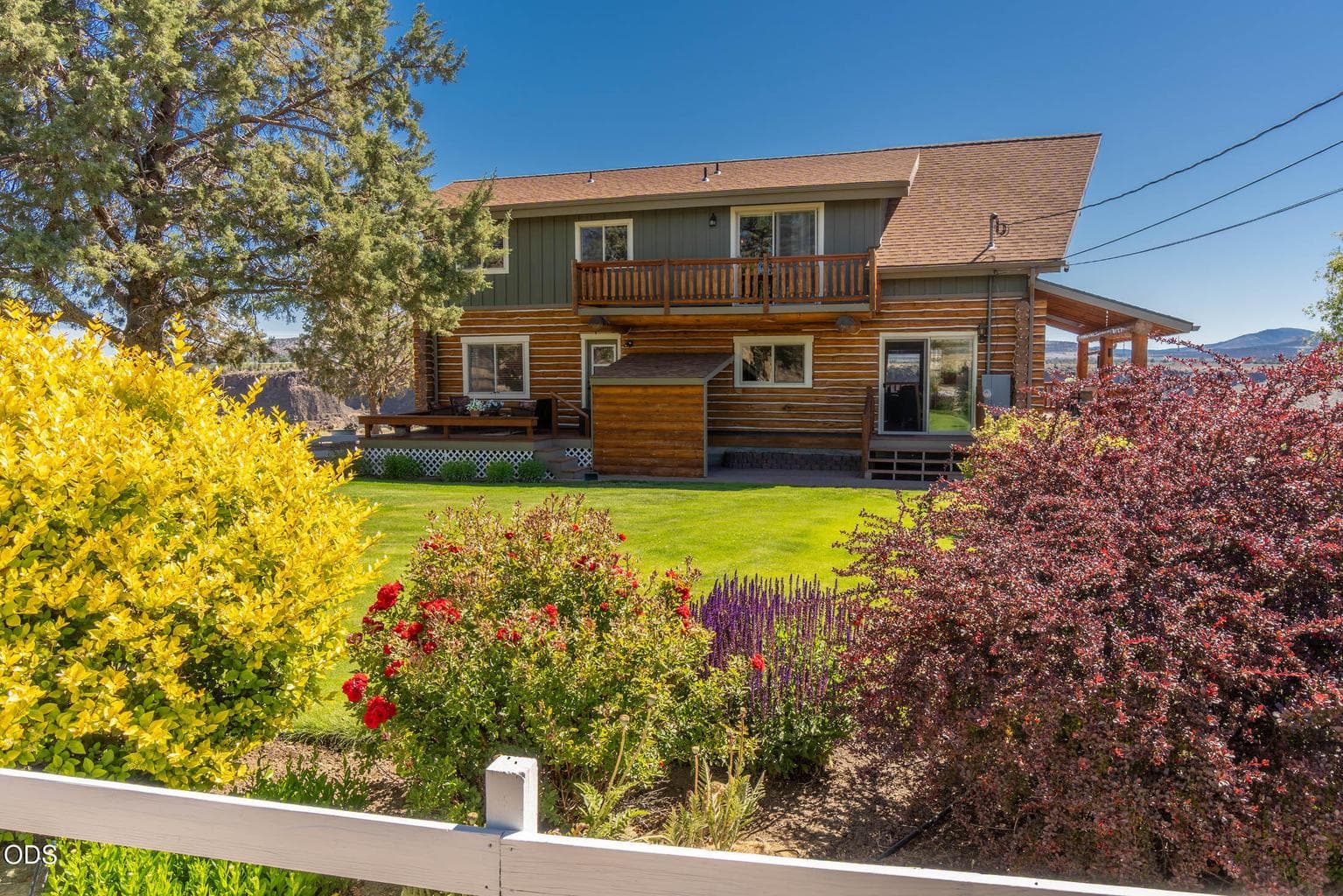 A beautiful, fenced garden with rock planters, sprinklers and drip system, just off the side patio and front deck.