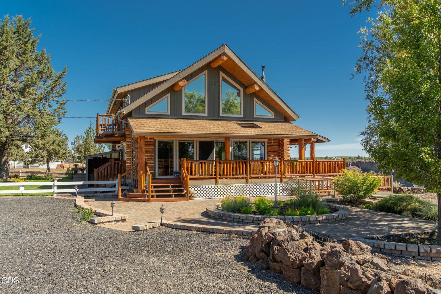 Mixed material design boasts the classic look of logs on the main level, with standard stick-framing of the upper level.