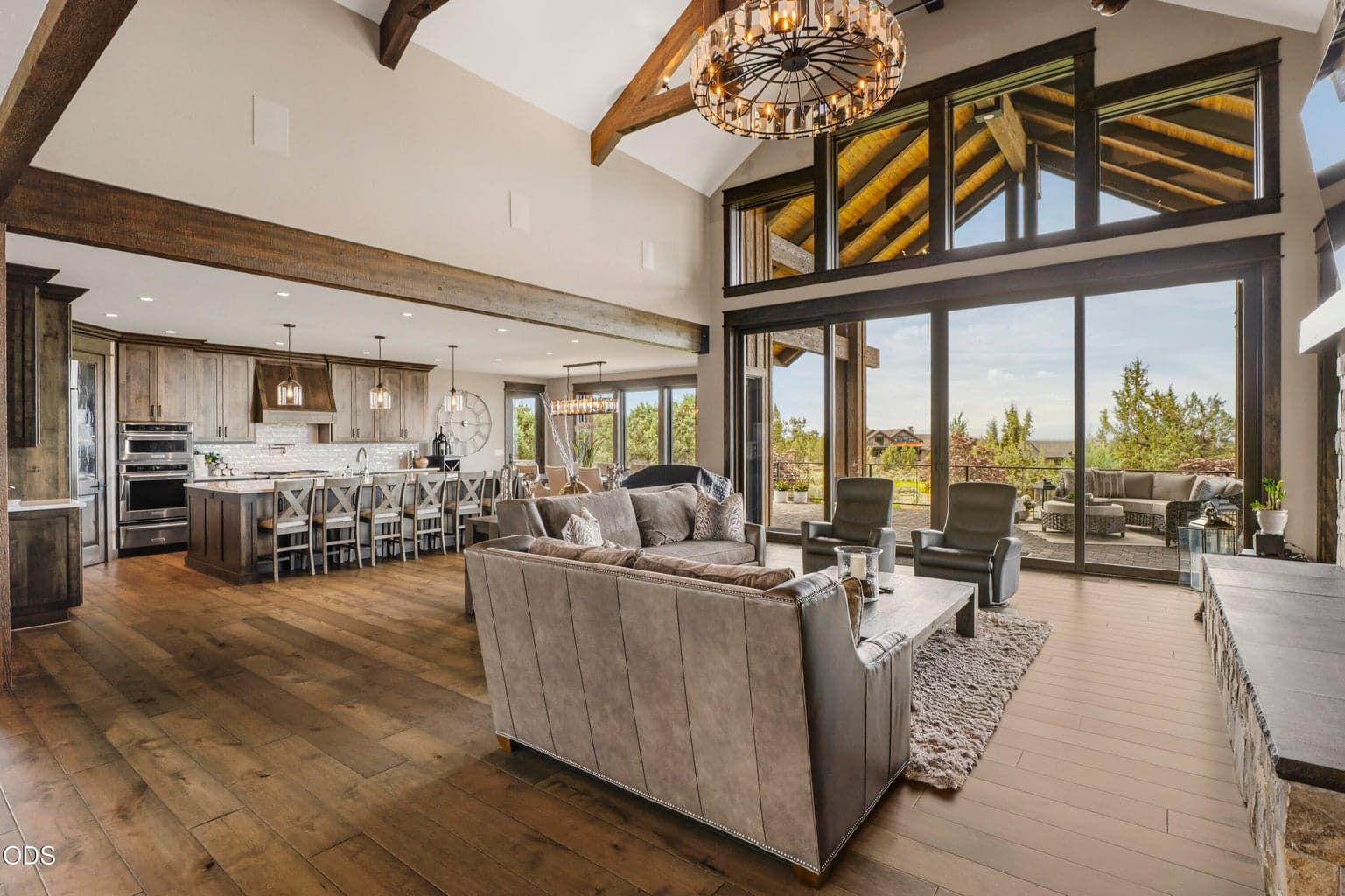 The focal point of the great room are the huge windows drawing the eye up to vaulted ceilings and dual sliding glass doors to fully capture the golf course and mountain views