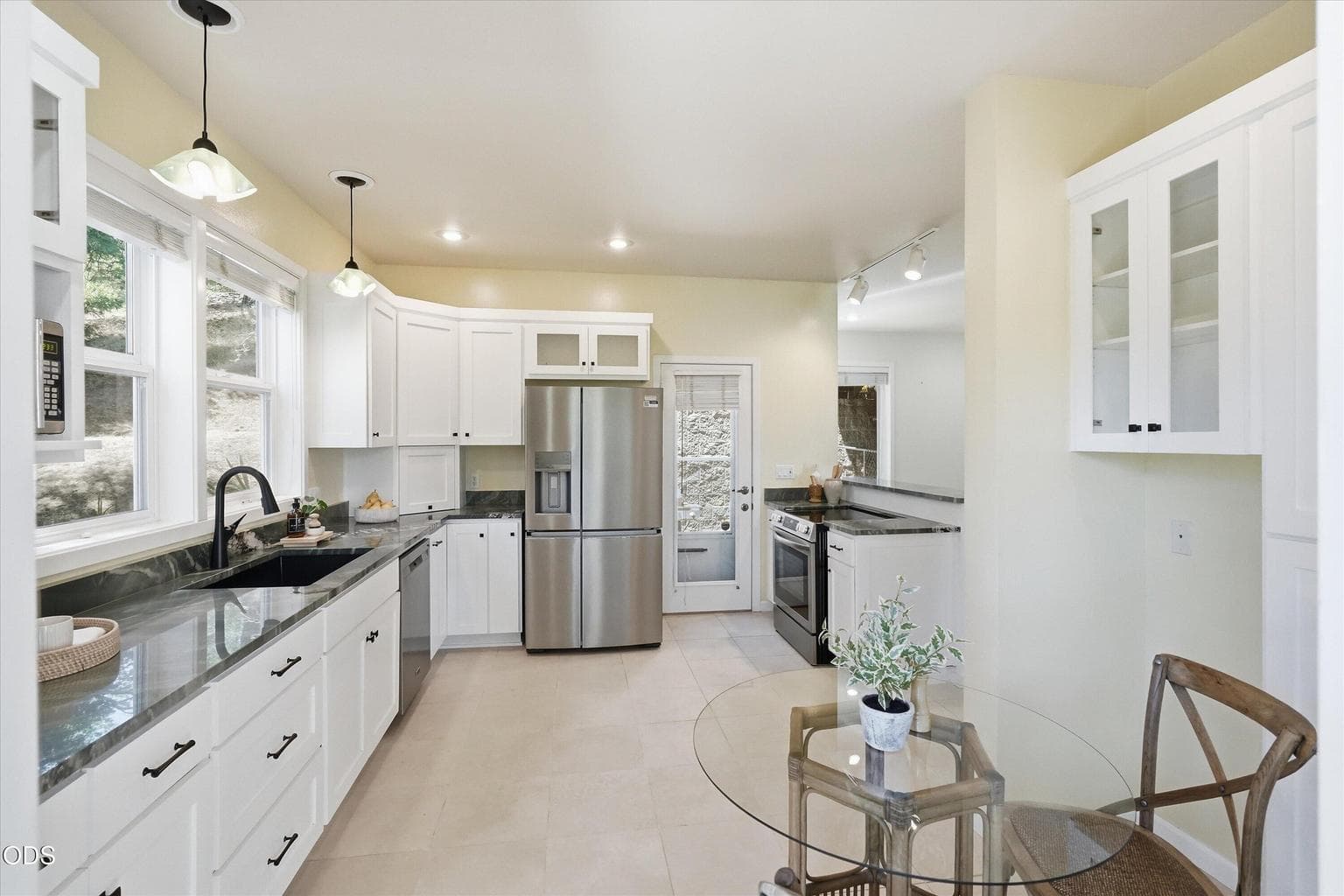 Gorgeous eat in kitchen with Brazilian quartzite countertops.